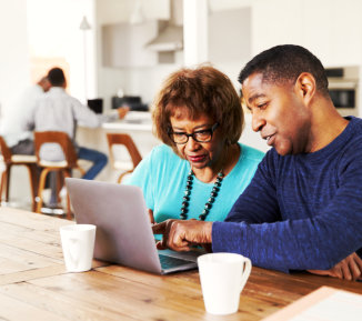 two people on a laptop