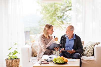 caregiver and old man talking each other