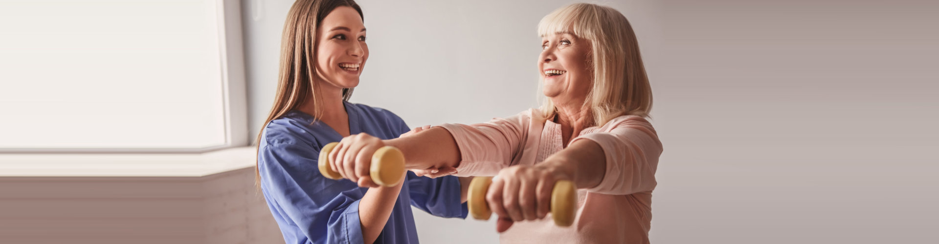 caregiver and old woman doing exercise