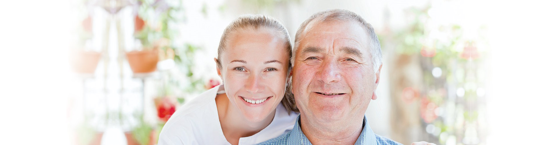 caregiver and old man are smiling