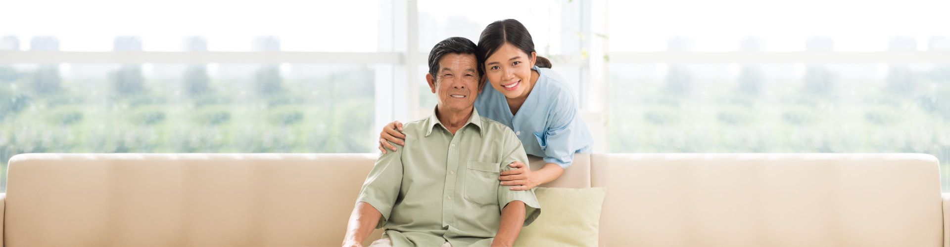 caregiver and senior man smiling